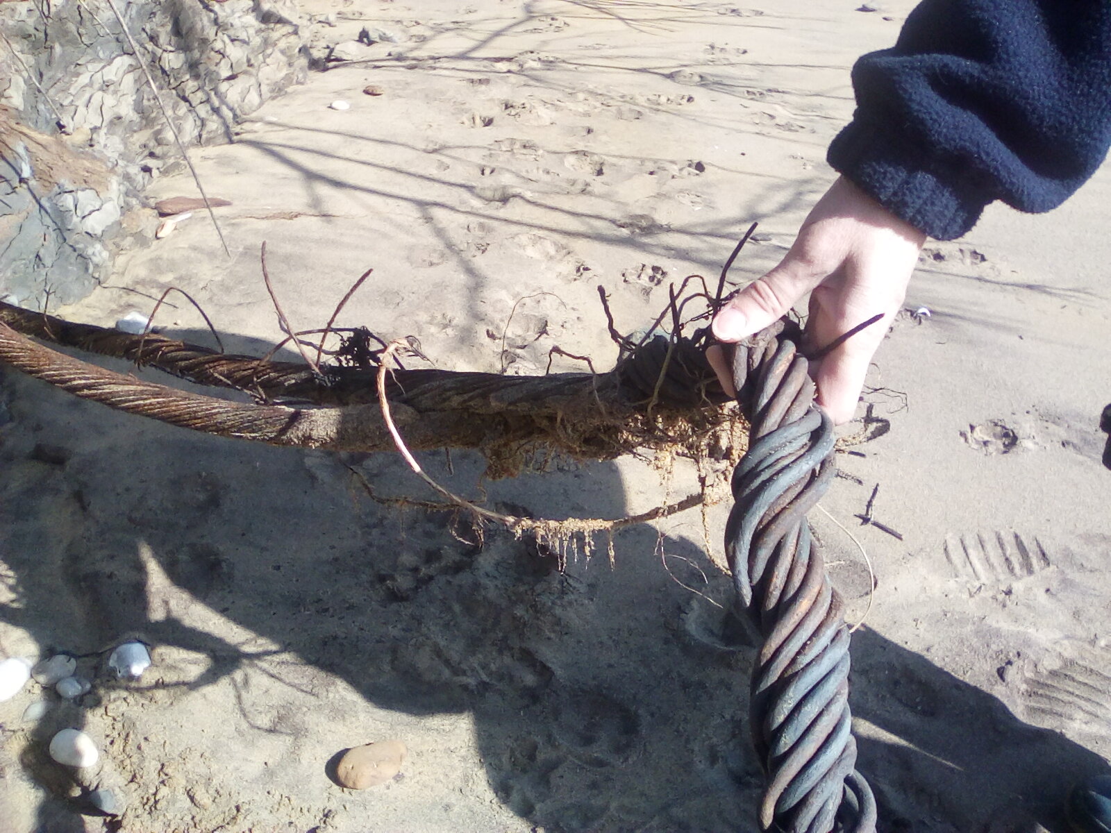 Closeup of Thick Twisted Wire laying on beach