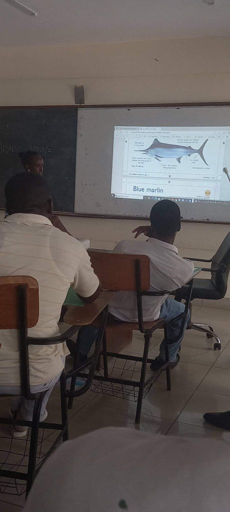 Students at Bandari Maritime Academy, sitting in a classroom, looking at slides about the Blue Marlin.